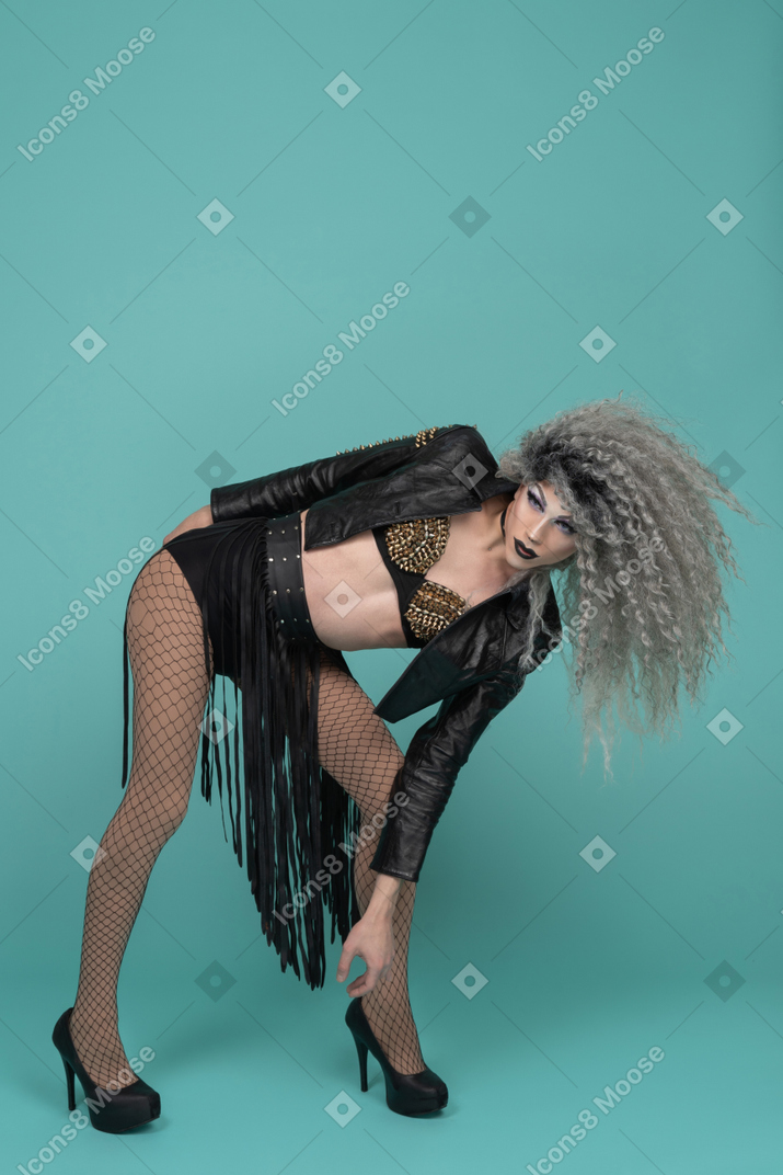 Drag queen in all black outfit bending sideways