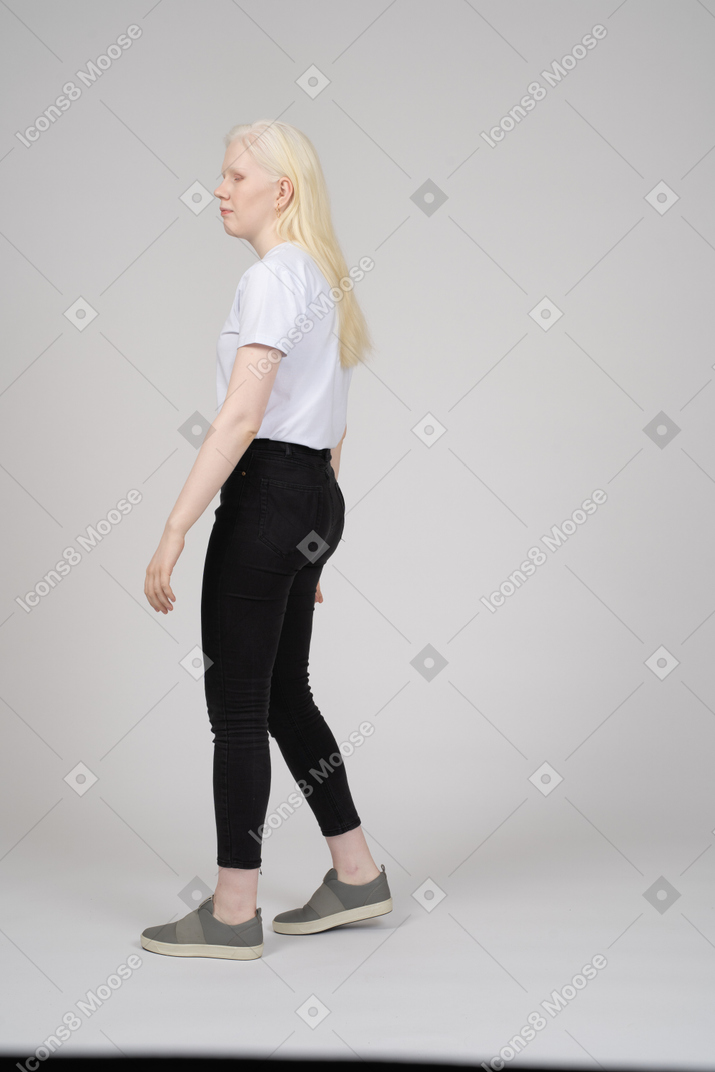 Side view of girl walking casually