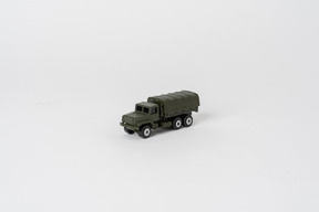 A toy army truck standing alone against a plain white background