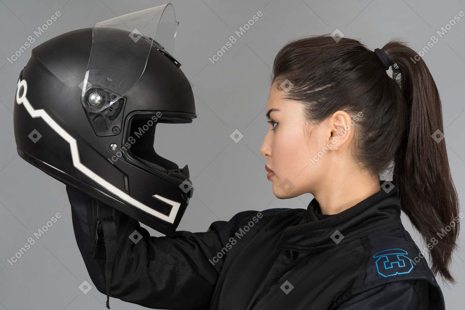 A beautiful young woman looking at a helmet