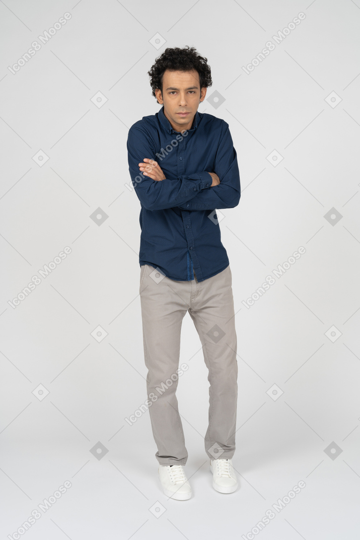 Front view of a man in casual clothes posing with crossed arms