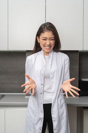 Front view of a female doctor smiling and outspreading