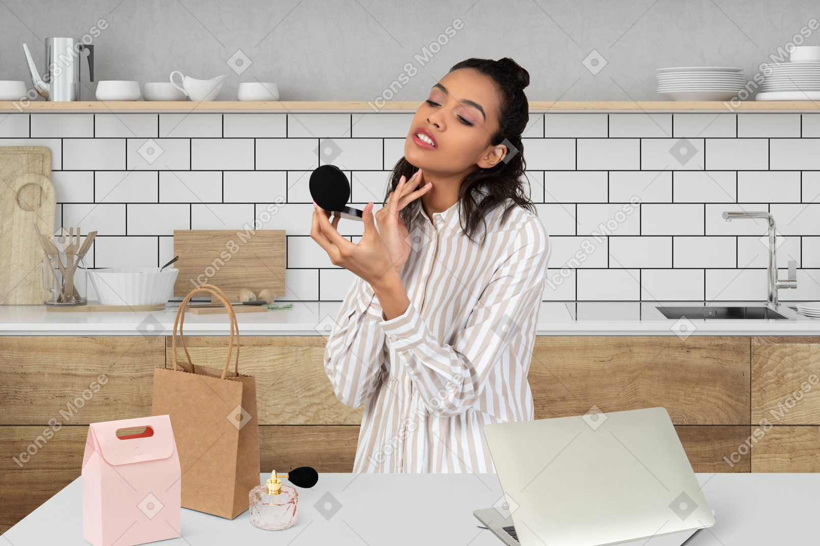 Young woman sitting at the table in the kitchen and using laptop