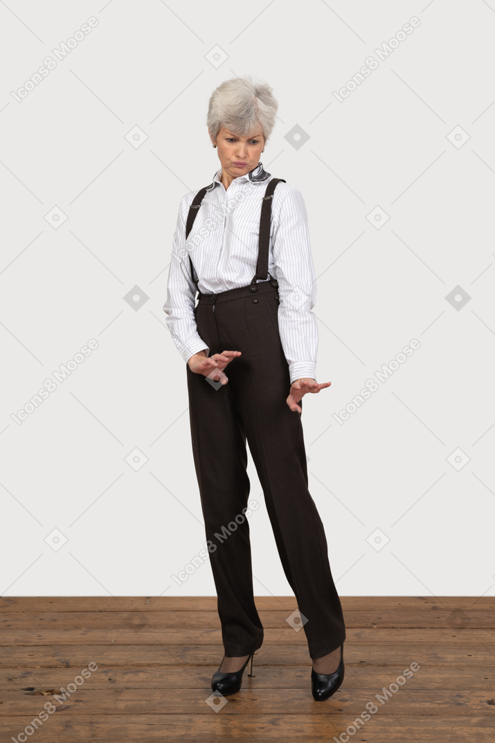 Front view of a careful old lady outstretching her hands
