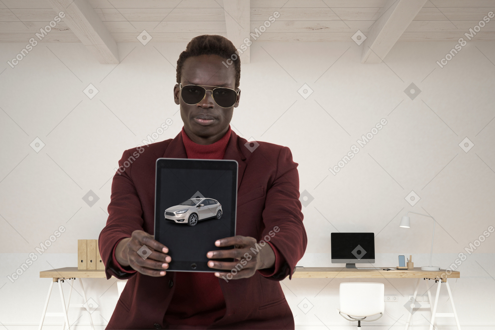 A man holding up a tablet with a car on it
