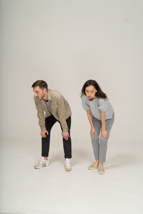 Tired young man and woman leaning on knees