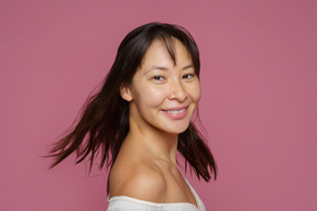 Motion picture of a female turning her head and looking happily at camera