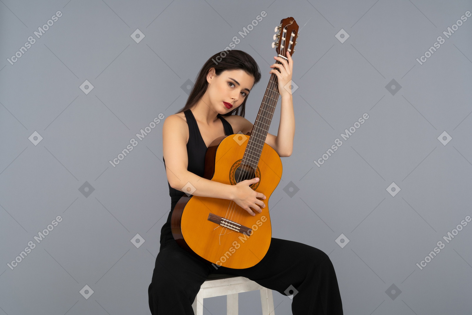 Attractive young woman posing with a guitar
