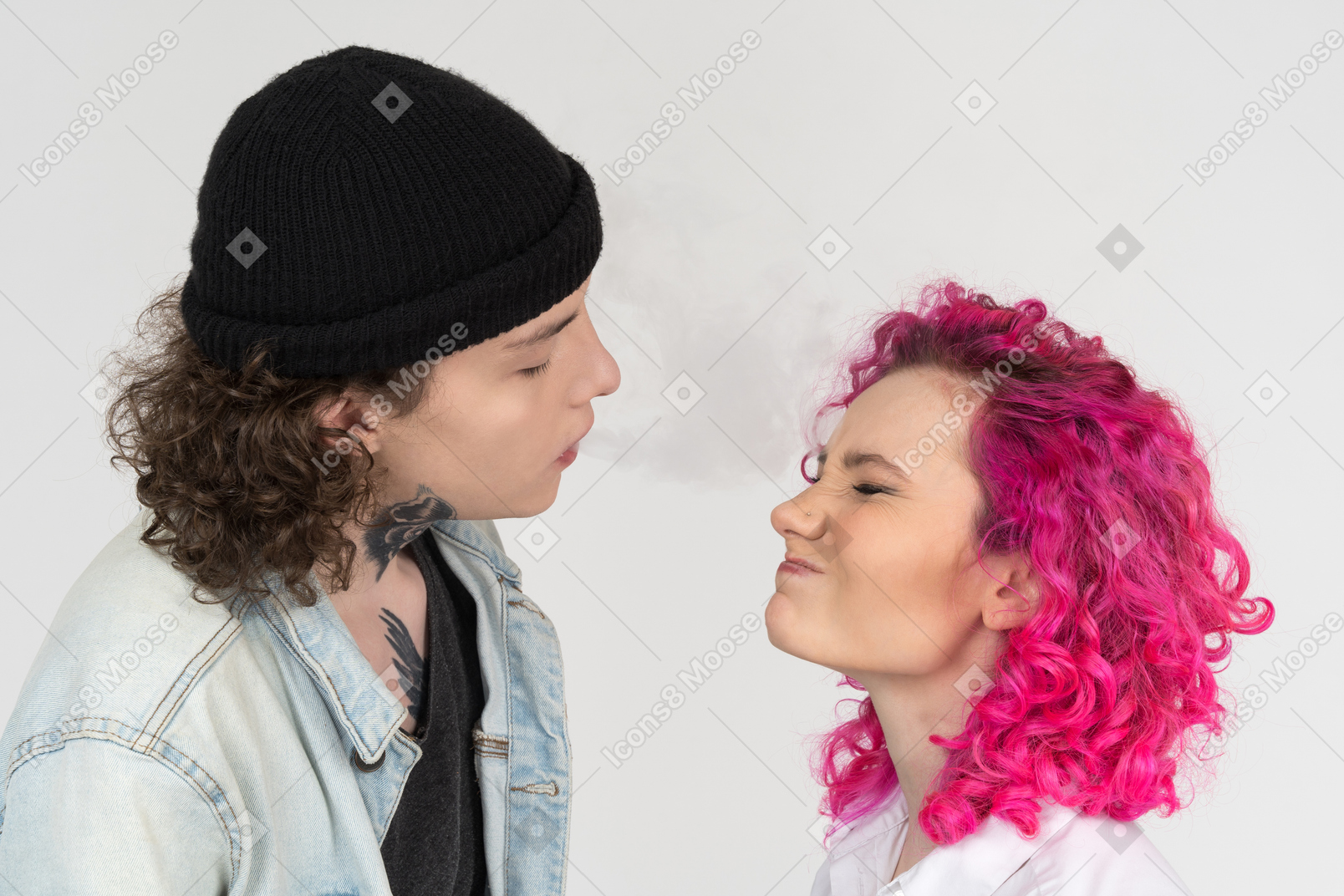 Male blowing smoke to his girlfriend's face