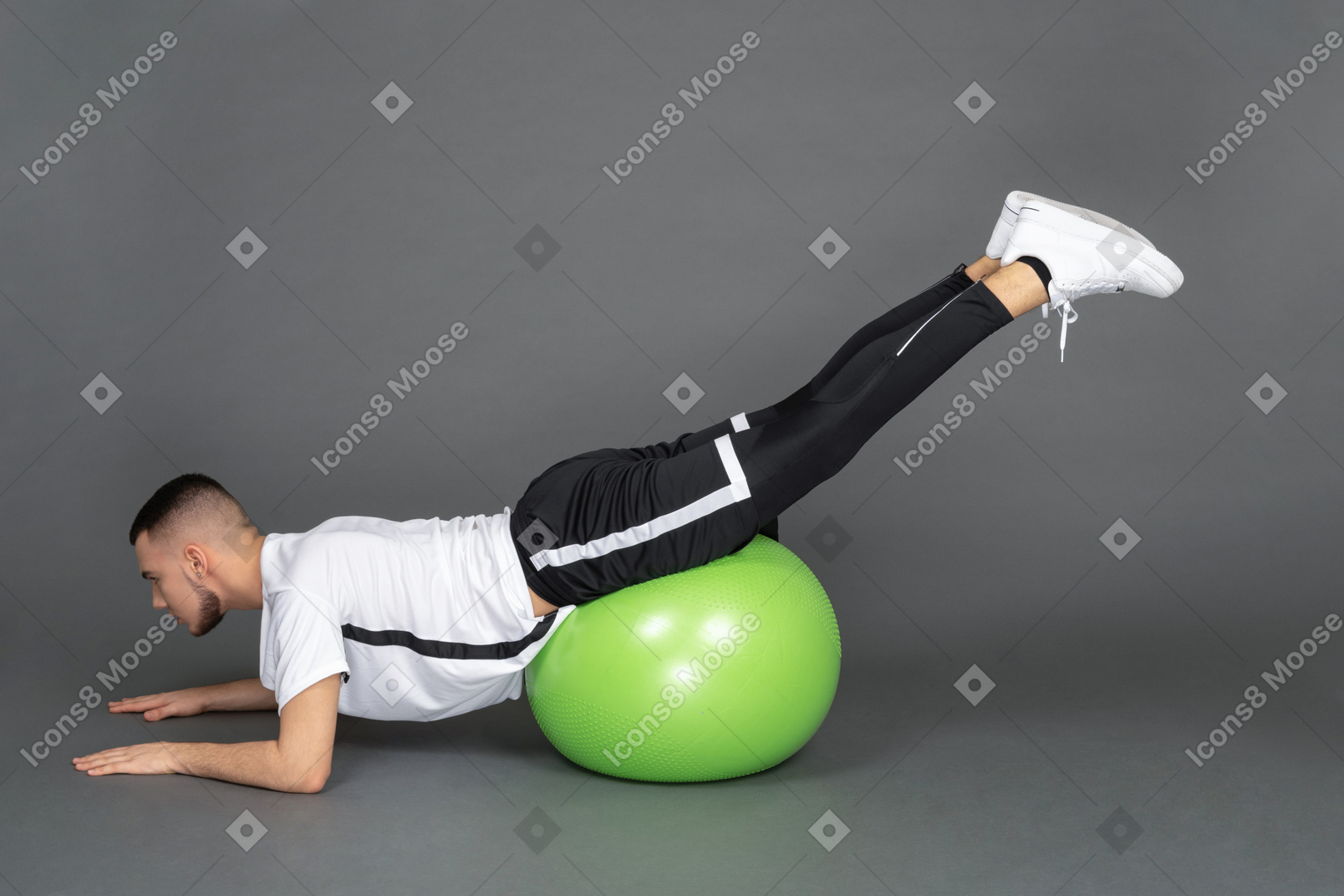 Young man doing exercises with a fitball