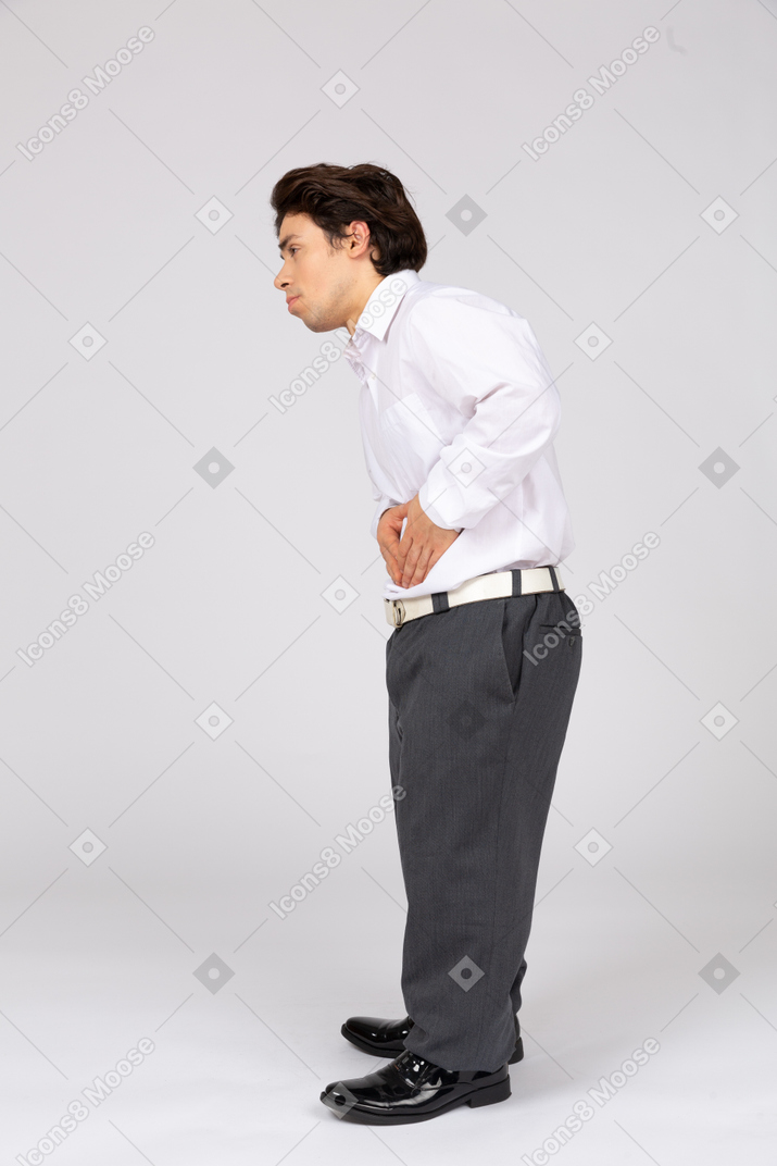 Side view of man with hands on stomach