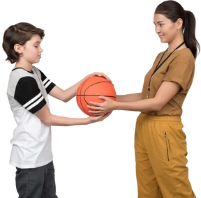 Pe female teacher and pupil holding a basketball ball