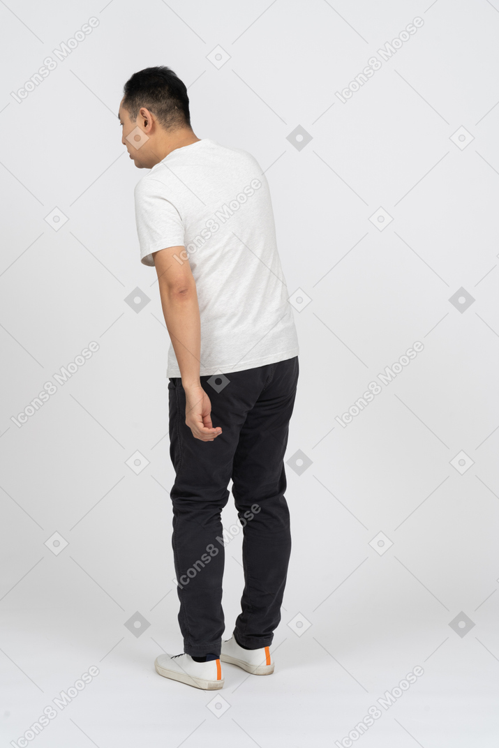 Rear view of a man in casual clothes eavsdropping