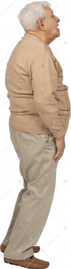 Side view of an impressed old man in casual clothes looking up