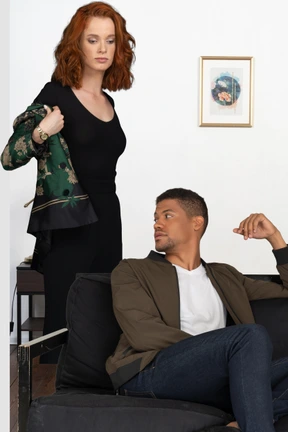 A man sitting on a couch next to a woman