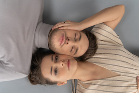 Overhead shot of a young couple lying side by side