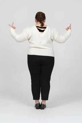 Plump woman in casual clothes posing