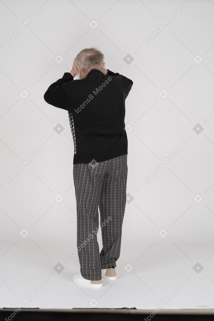 Back view of old man holding head