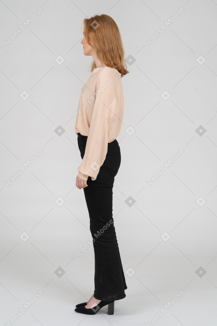 A woman standing in front of a wall