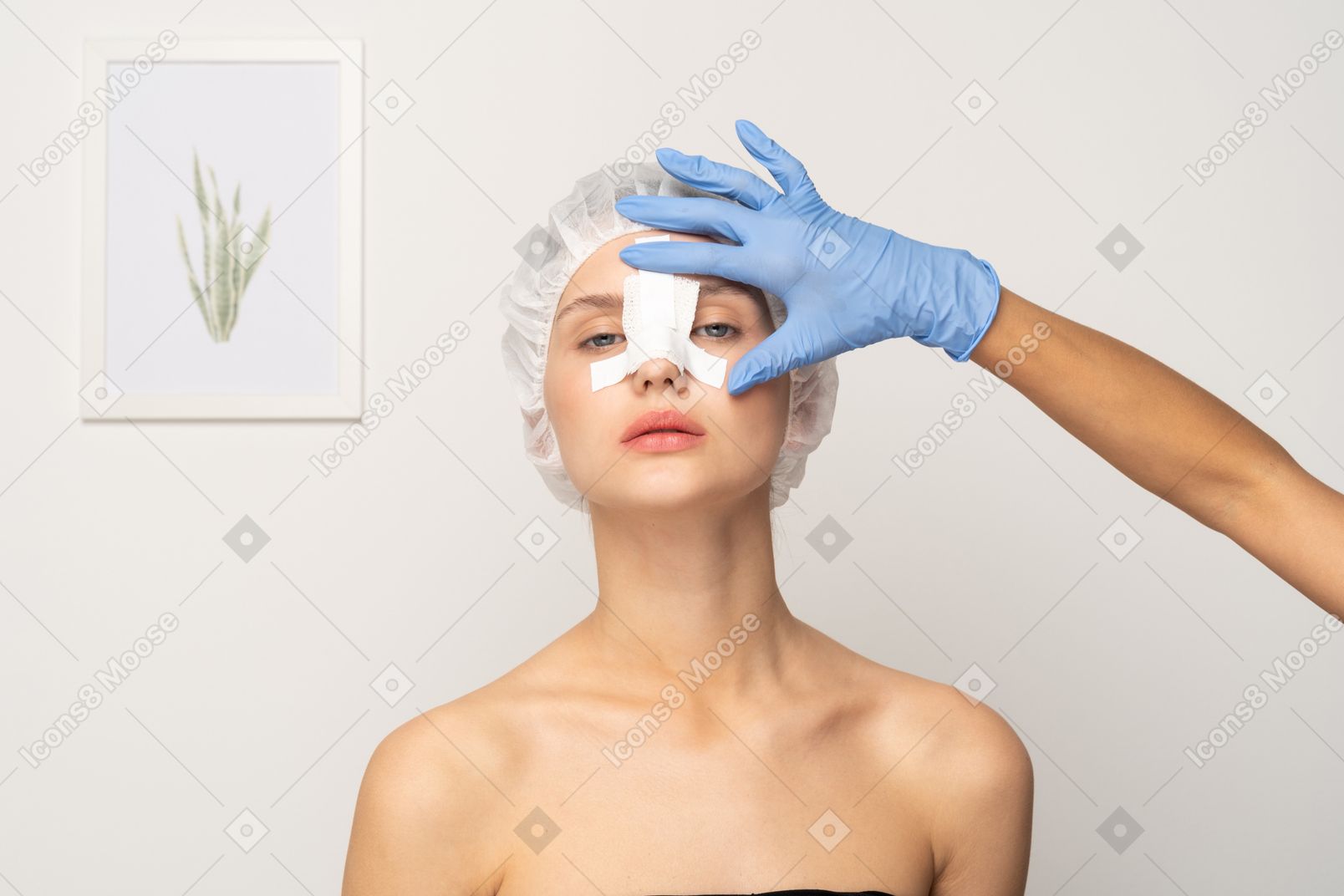Nurse applying medical tape to young woman's nose