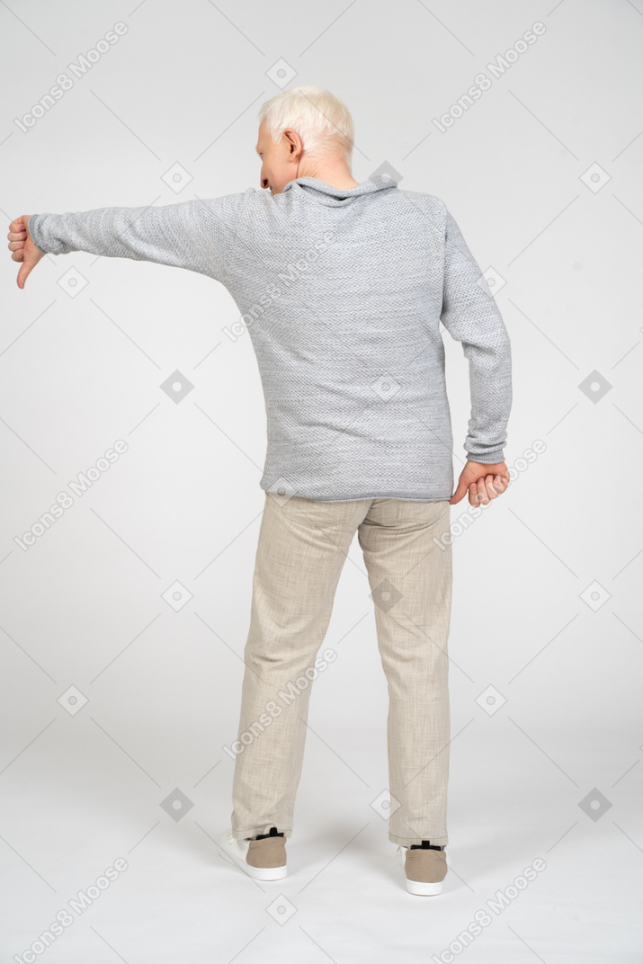 Rear view of man giving thumbs down