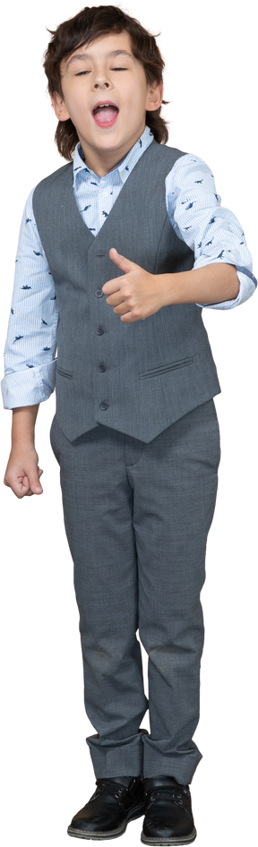Front view of a boy in grey suit showing thumb up