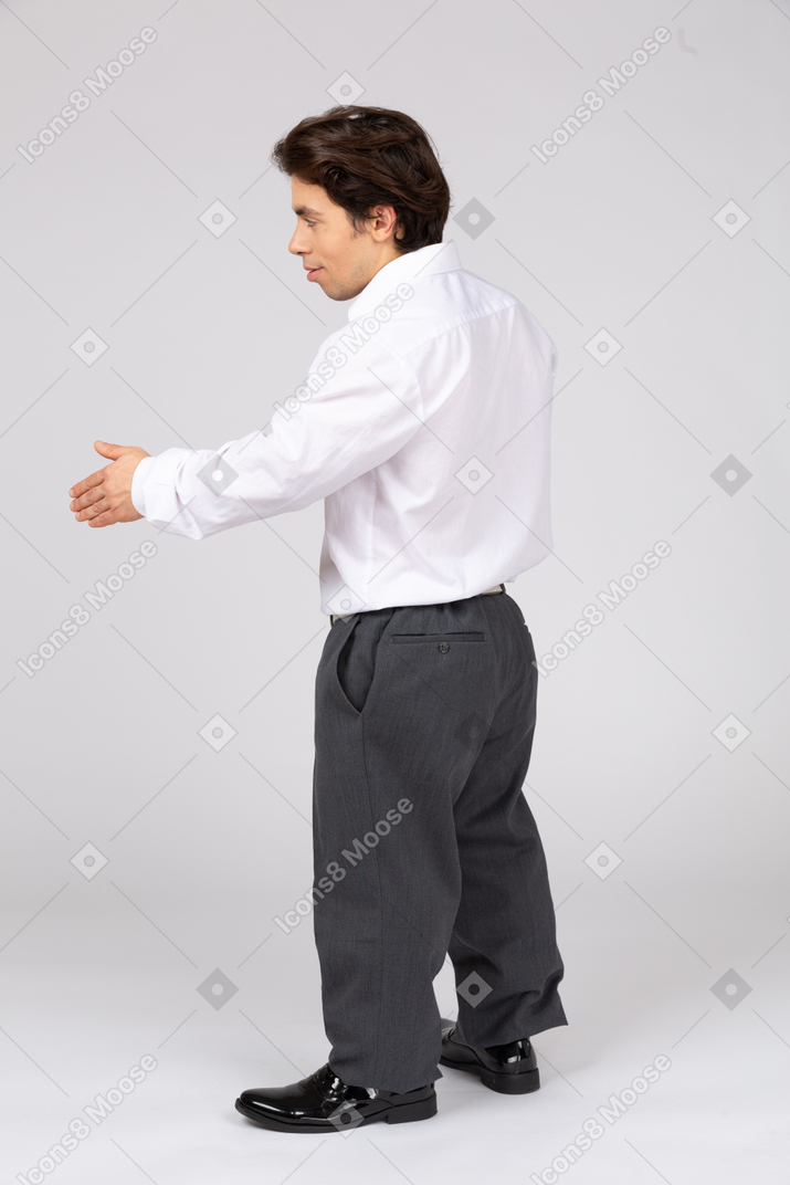Side view of an office worker holding out hand for a handshake
