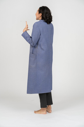 Rear view of an excited woman in a coat