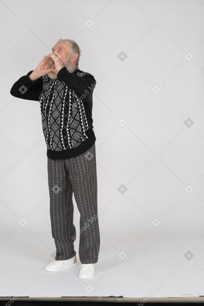 Shouting senior man with cupped hands around mouth