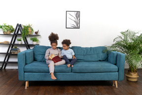 Good looking boy and girl play on the sofa