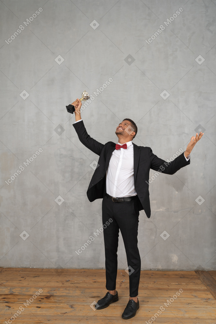 Man holding up award in celebration of his win