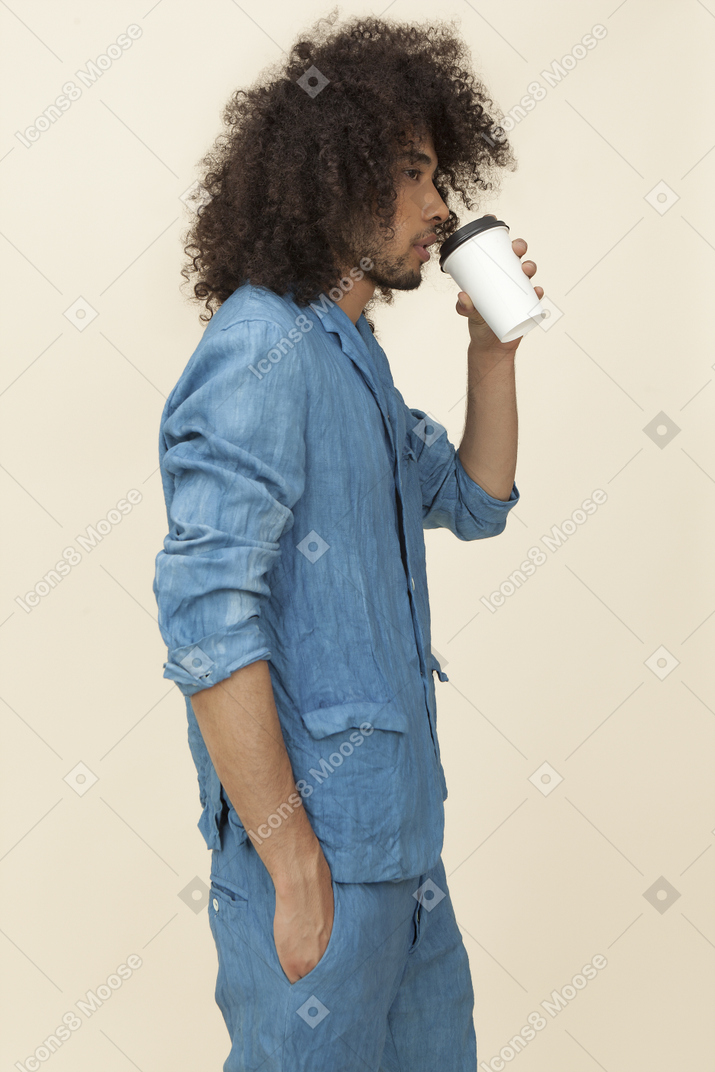Afroman in denim suit holding cup of coffee