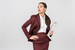 Attractive formally dressed woman holding a clipboard