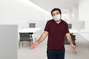 A man wearing a face mask in an office