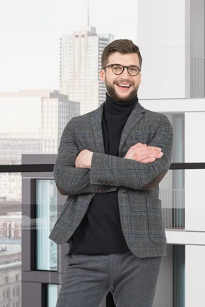 A man in a suit standing with his arms crossed