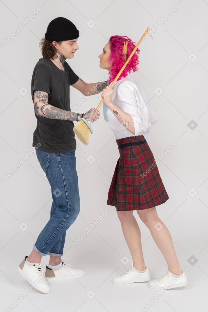 A young couple arguing who is going to wash the floor