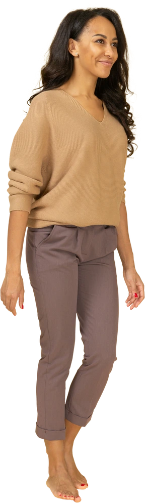 Three-quarter view of a dark-skinned young female smiling