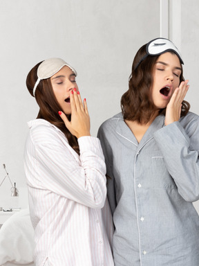 Women in pajamas yawning