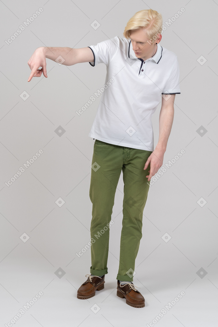 Young man pointing down