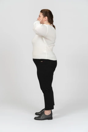 Plump woman in casual clothes making faces