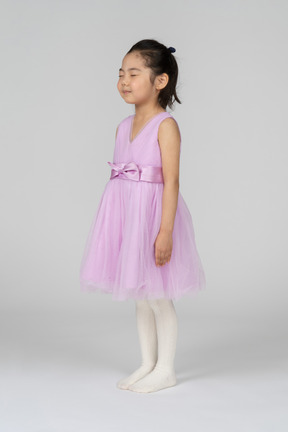 Little girl in pink dress closed eyes