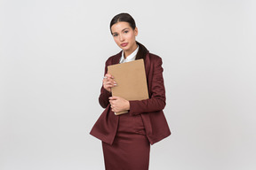 Attractive formally dressed woman holding a clipboard