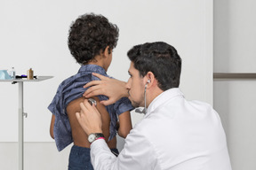Doctor examining a child with stethoscope