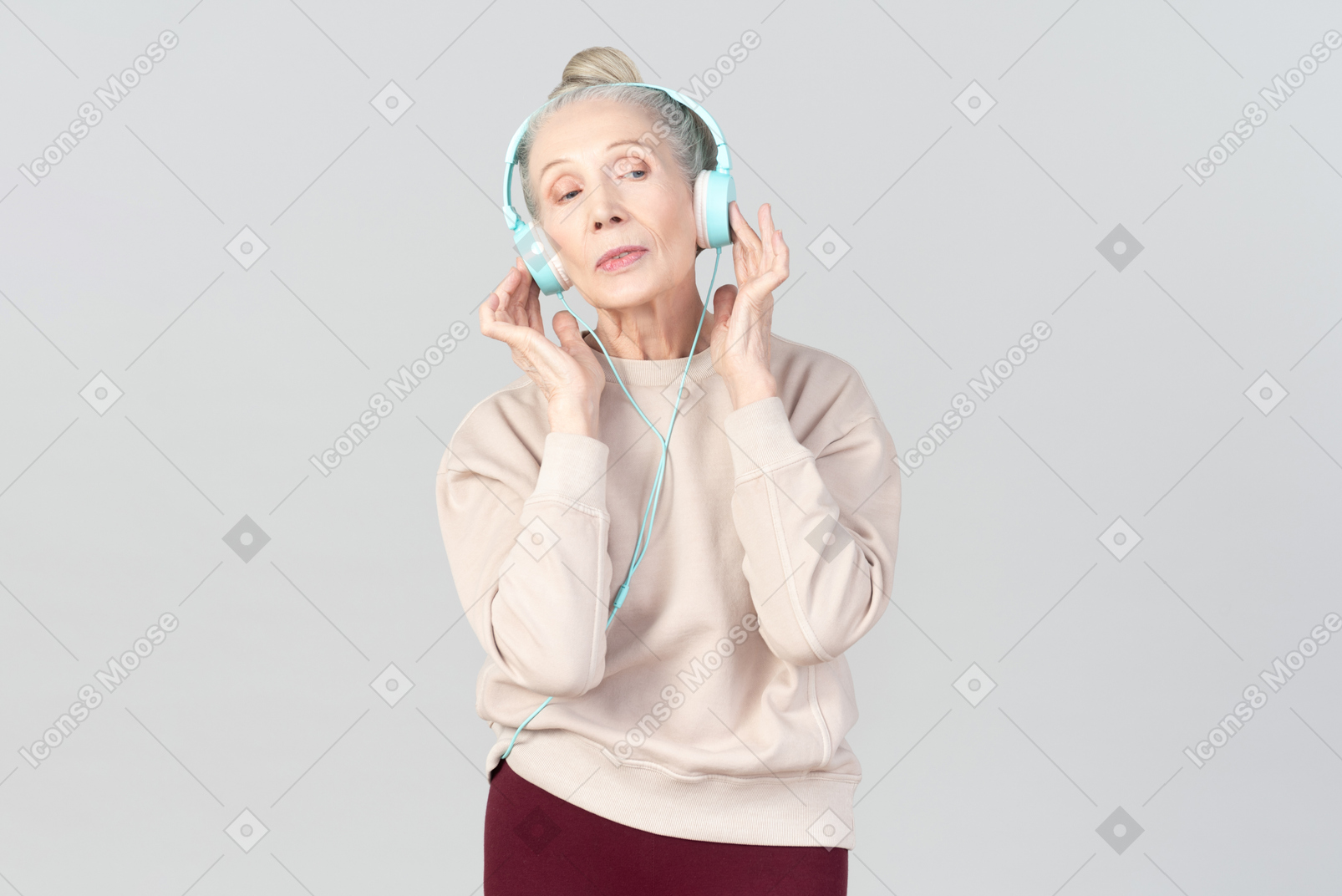 Old lady in listening music in headphones