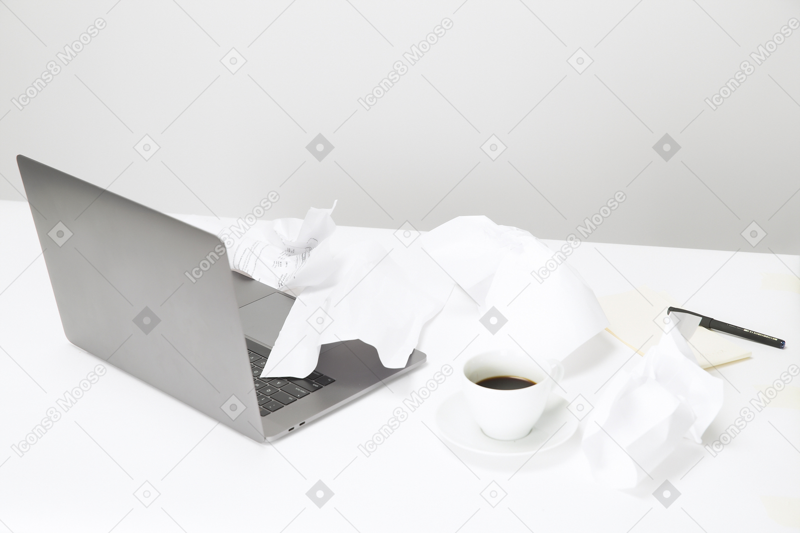 Crunched paper, cup of coffee and macbook