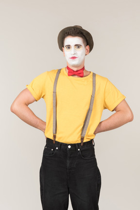 Male clown standing with hands on his hips