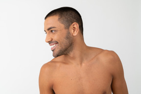 Barechested young male smiles