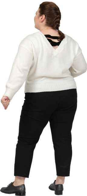 Plump woman in white sweater standing