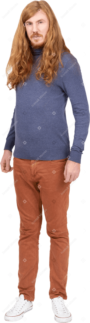 Young man in casual clothes looks at camera