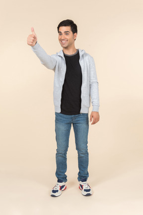 Smiling caucasian man showing thumbs up